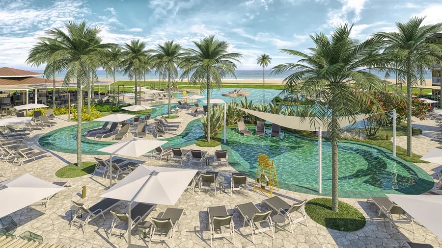 área de lazer com piscina, cadeiras, coqueiros e guarda-sol Sauípe Premium