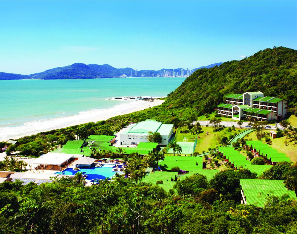 A vista aérea do resort com mar e montanha em volta Infinity Blue
