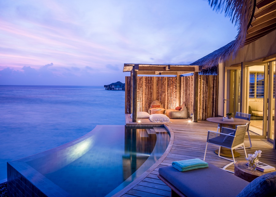 A piscina privativa da Villa com por do sol, cadeiras, mesas, espreguiçadeiras e luzes InterContinental Maldives